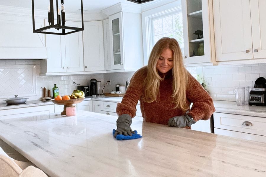 Woman cleaning kitchen countertops