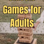 A jenga style outdoor game on grass.