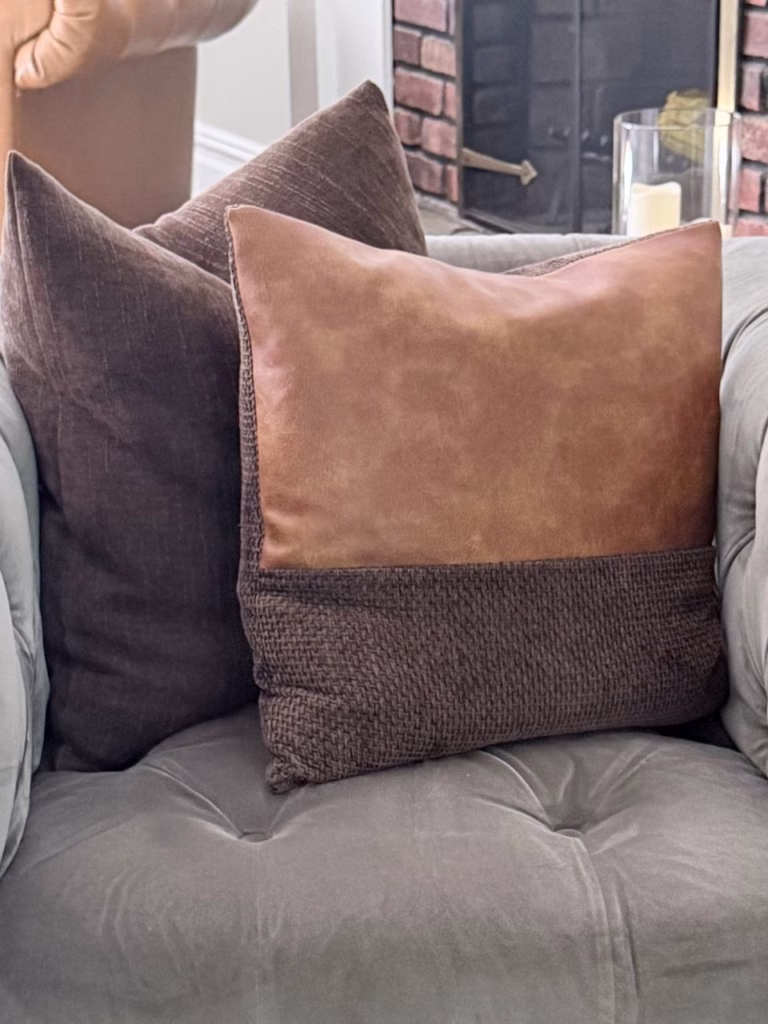 Two brown pillows sitting on a blue gray chair
