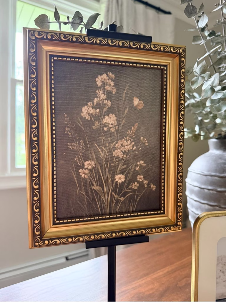 Small painting of flowers in a gold frame