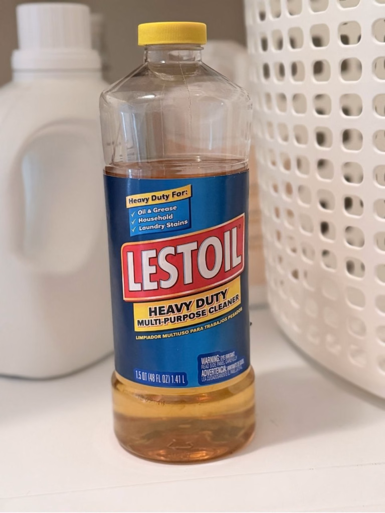 A bottle of Lestoil in front of other laundry detergents