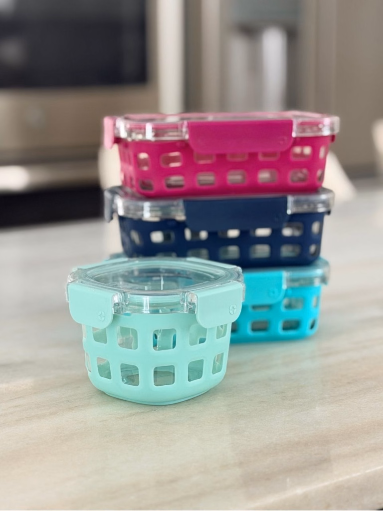Ello glass storgage containers in different colors on a counter
