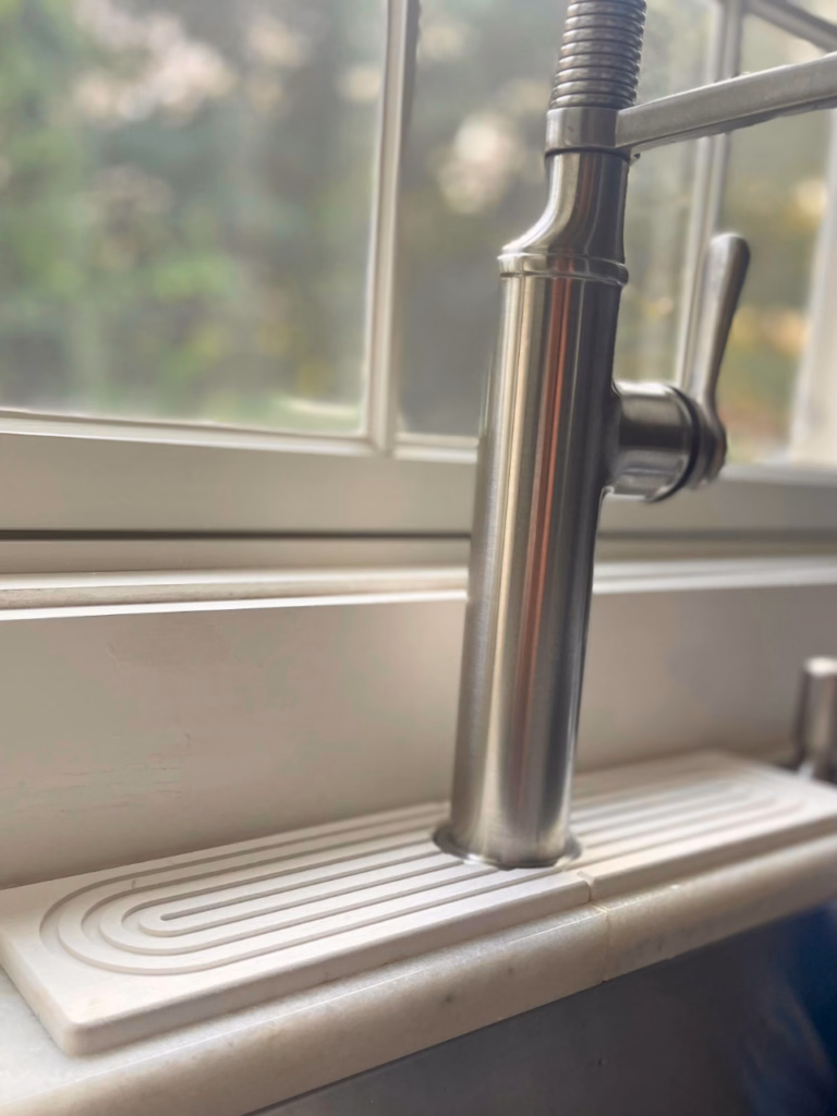 sink with a faucet mat